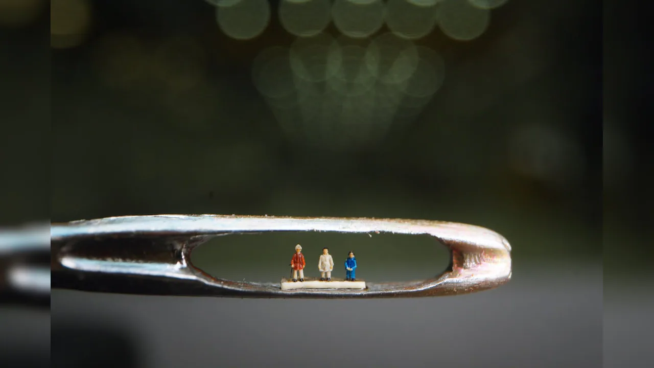 Microart sculpture resting on a rice grain